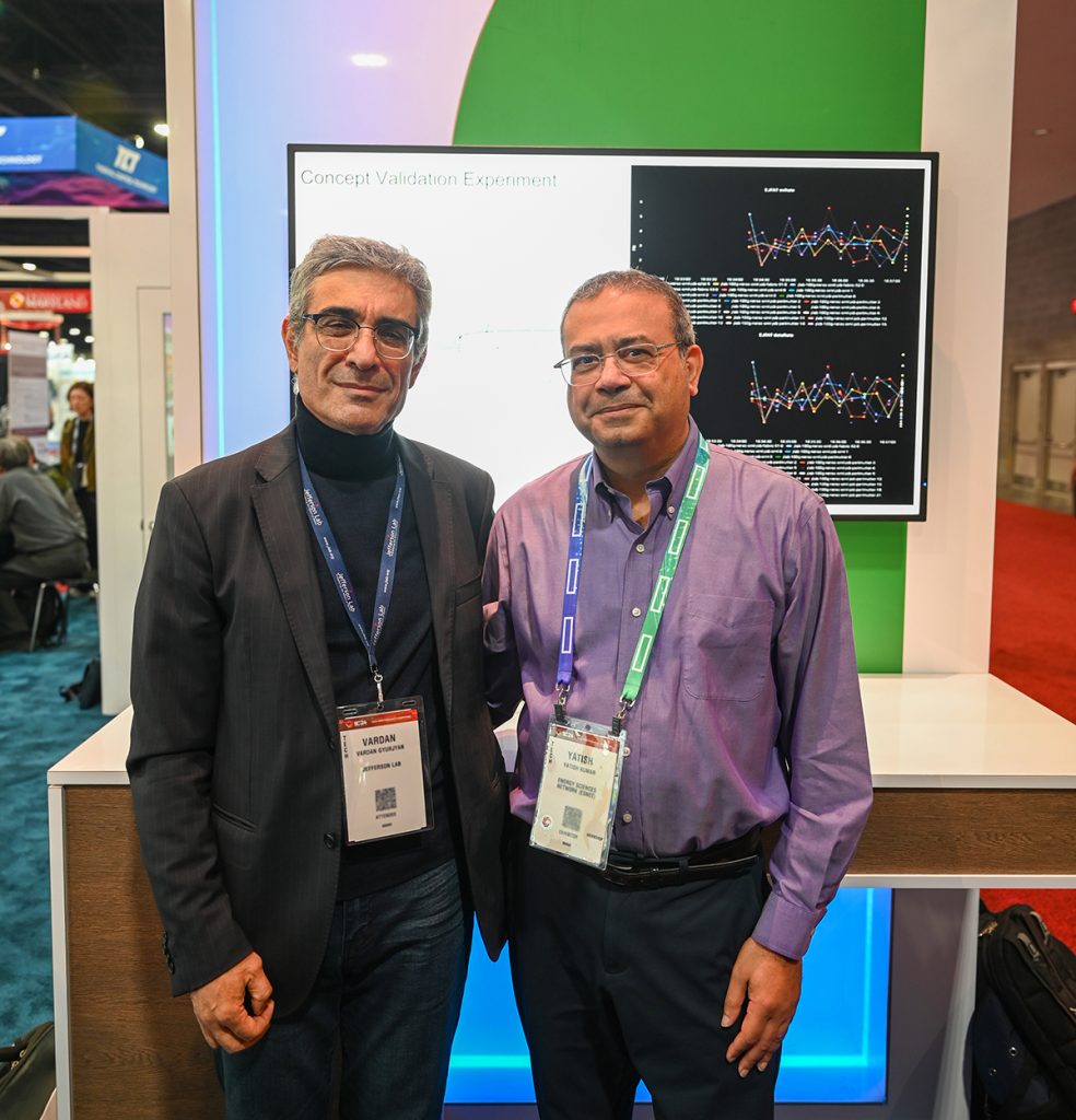 Two men in front of a demo station